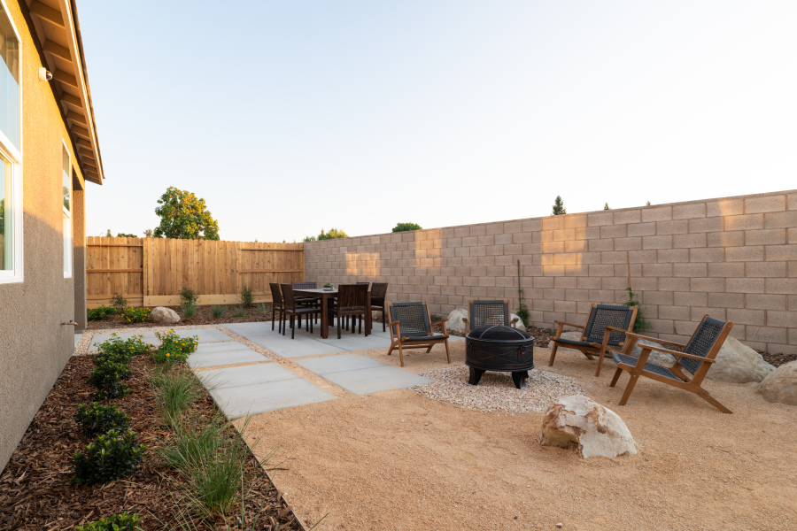A patio with chairs and tables.