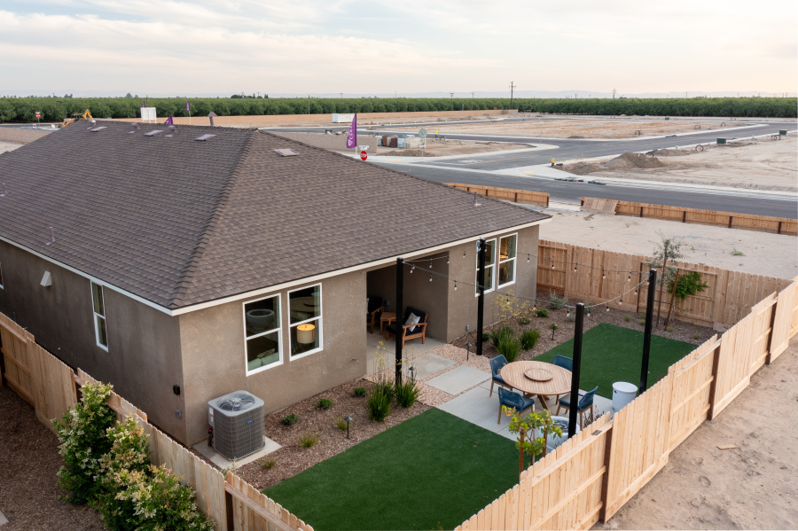 A house with a yard and a fence.