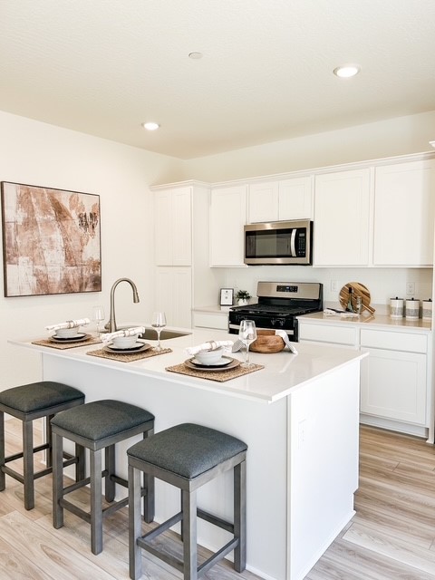 A kitchen with stools and a table.