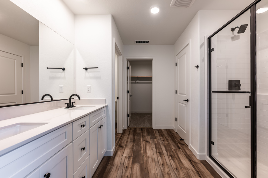 A kitchen with white cabinets.
