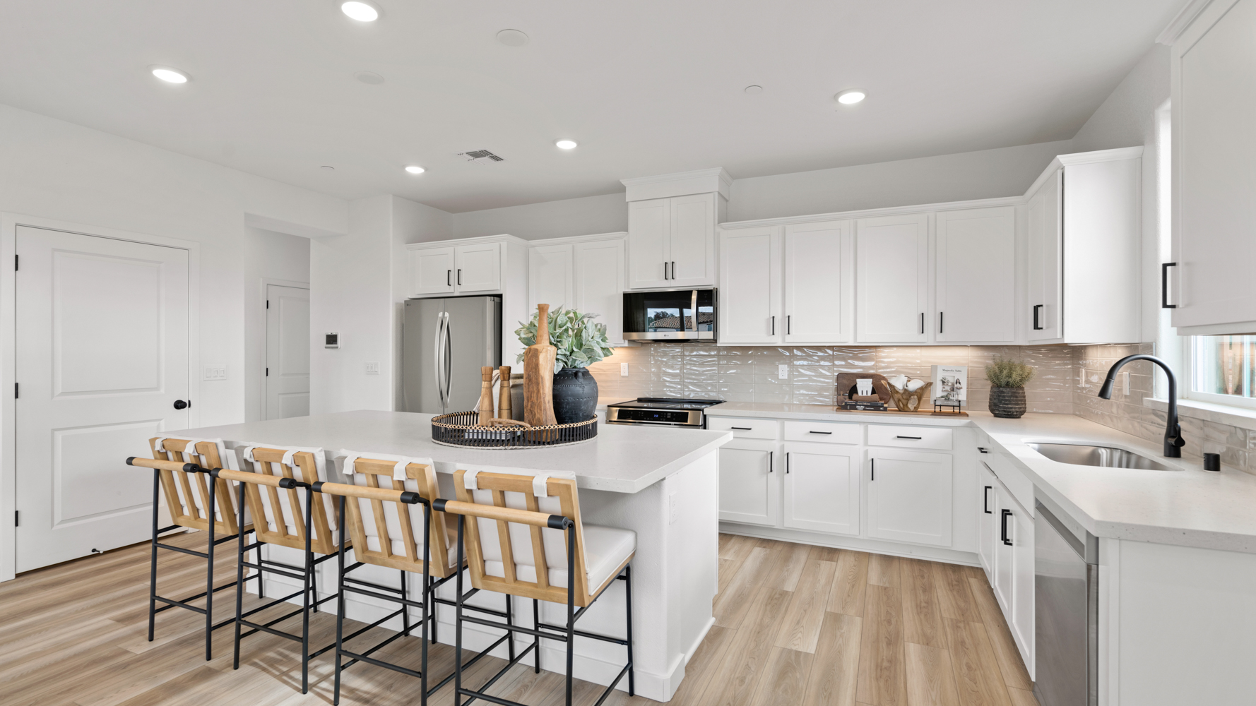 A kitchen with white cabinets.