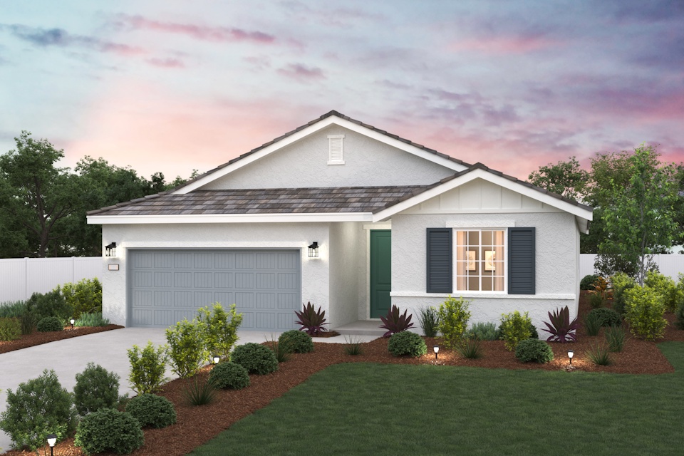 A house with a driveway and a lawn with bushes and trees.