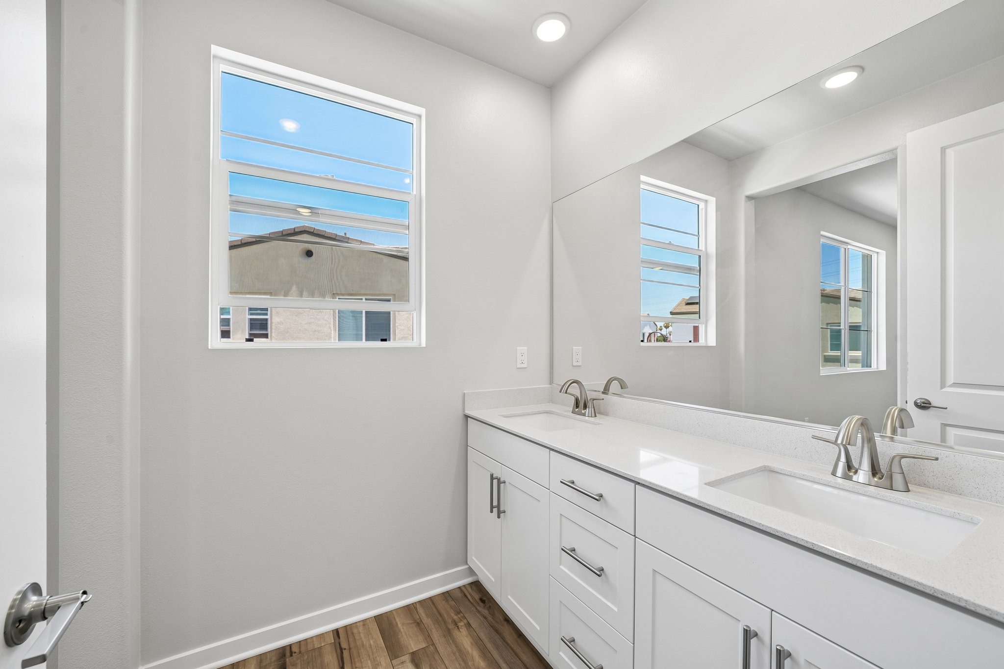 A bathroom with a large mirror.