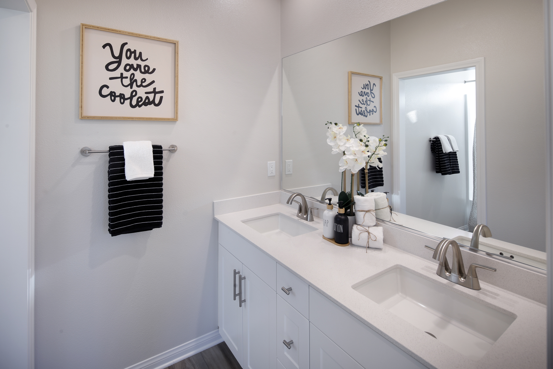 A bathroom with a mirror and sink.