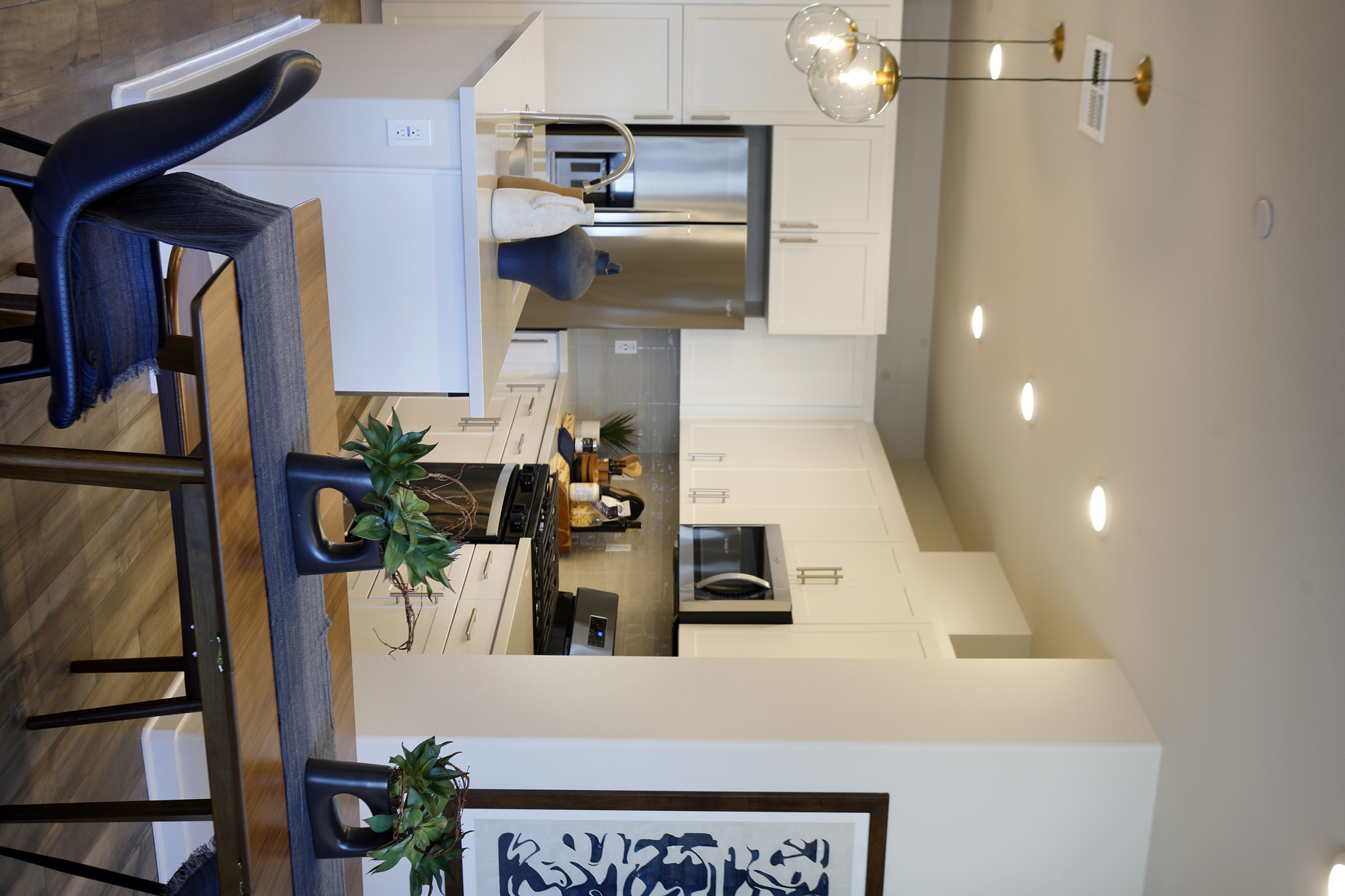 A kitchen with white cabinets.