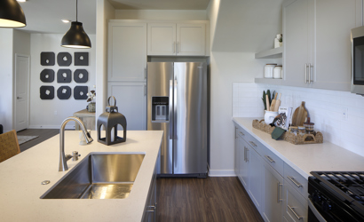 A kitchen with white cabinets.