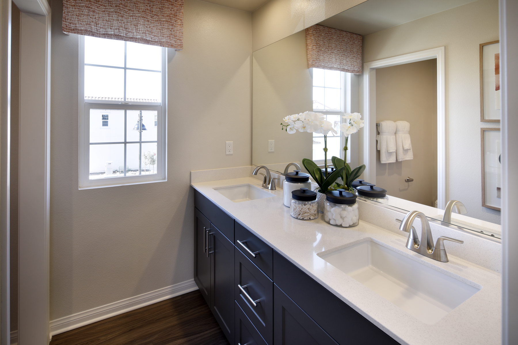 A bathroom with a large mirror.