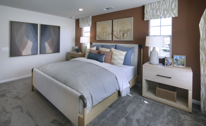 A bedroom with a bed and lamps.
