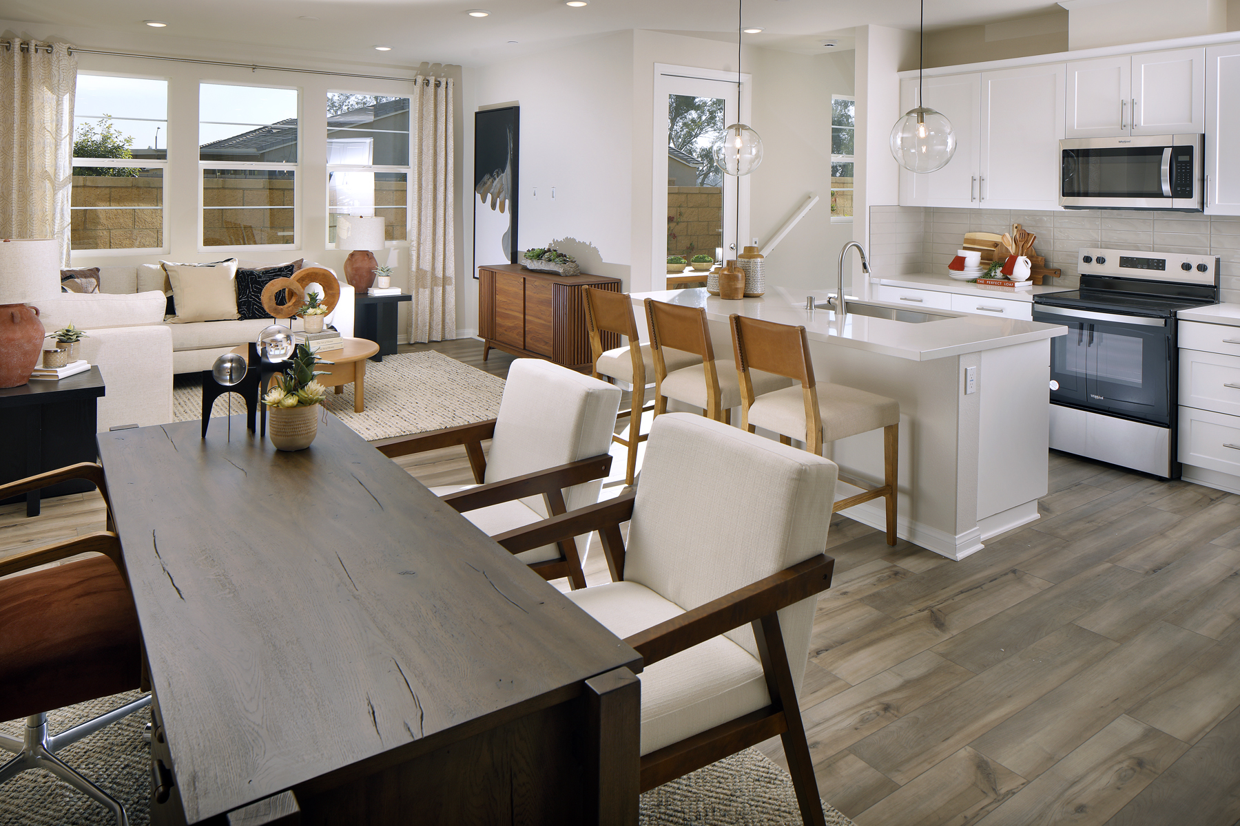 A kitchen with a dining table and chairs.