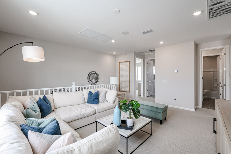 A living room with white couches.