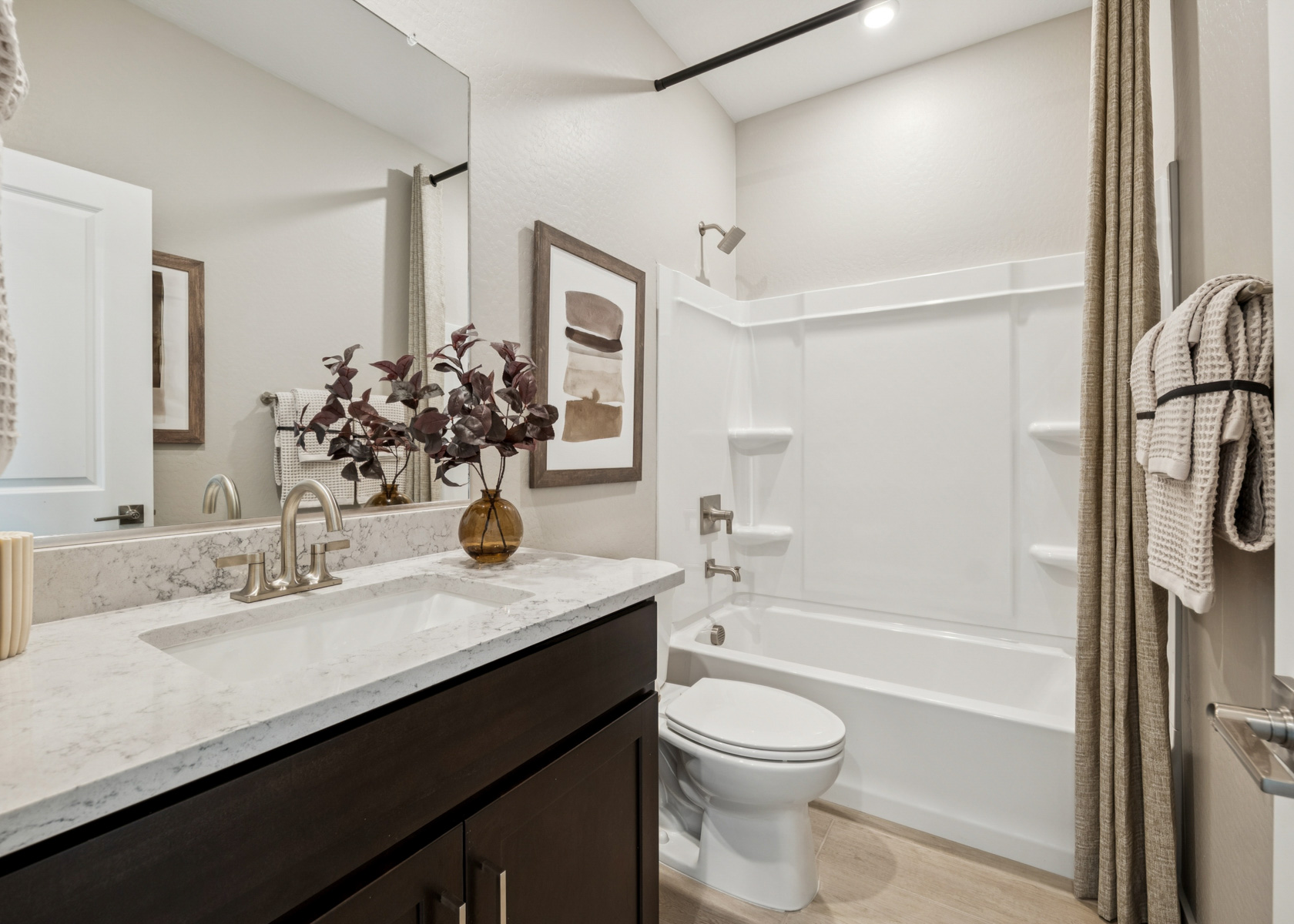 A bathroom with a sink toilet and bathtub.