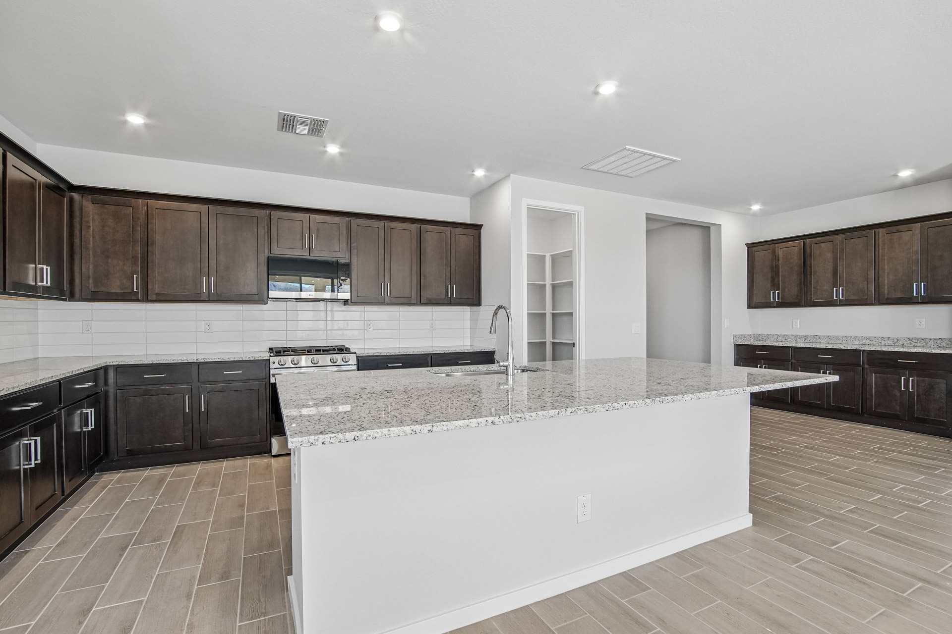 A kitchen with a marble counter top.