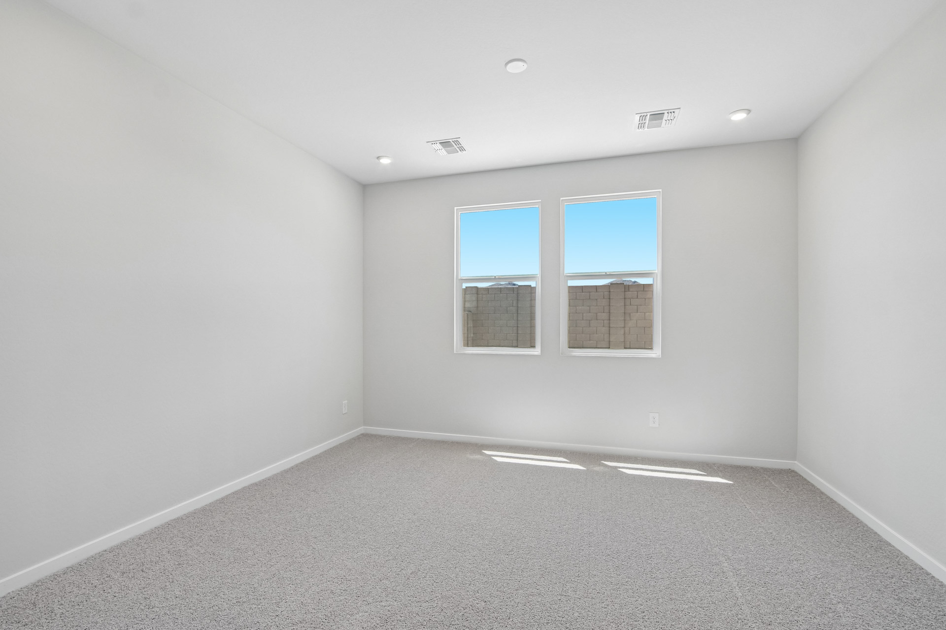 A room with a window and a carpet.