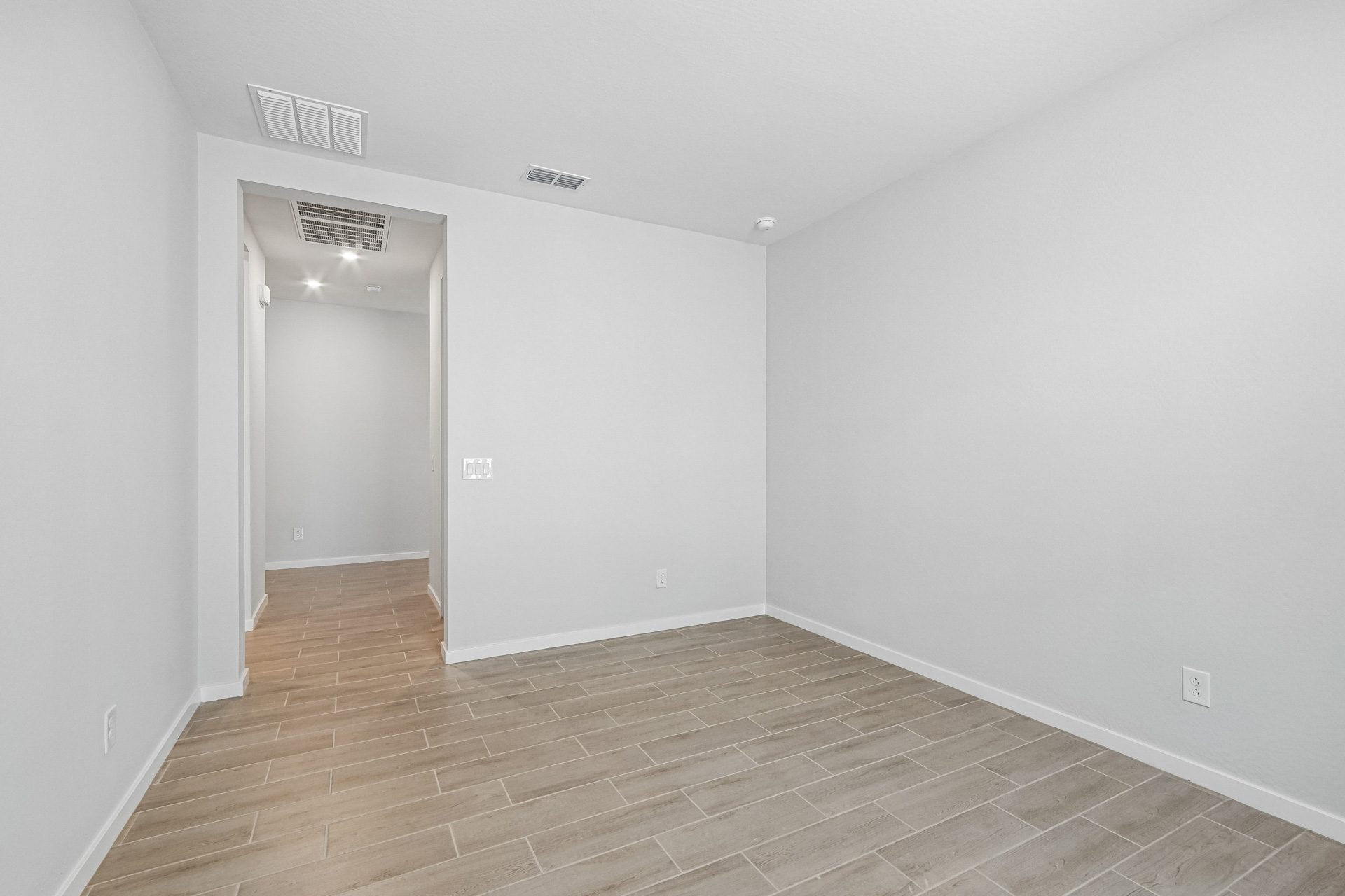 A room with a tile floor and a door.