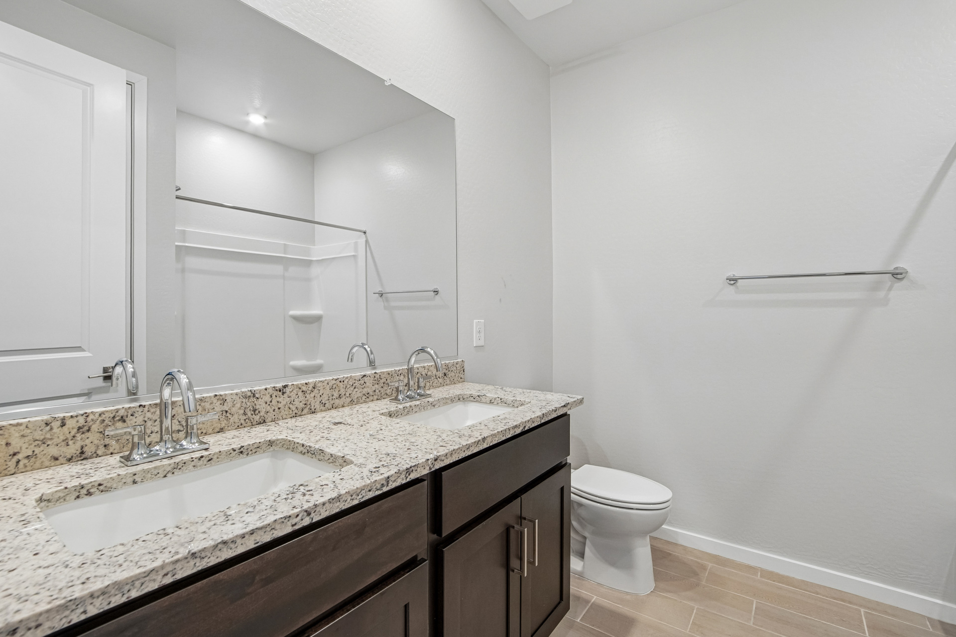 A bathroom with a large mirror.