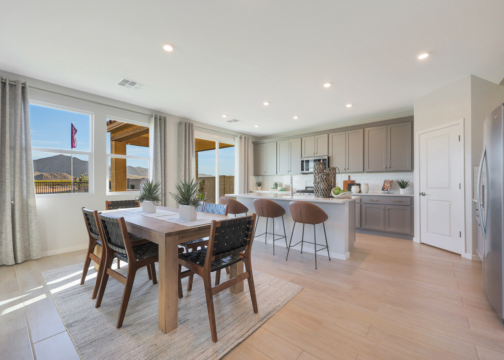 A kitchen with a dining table and chairs.
