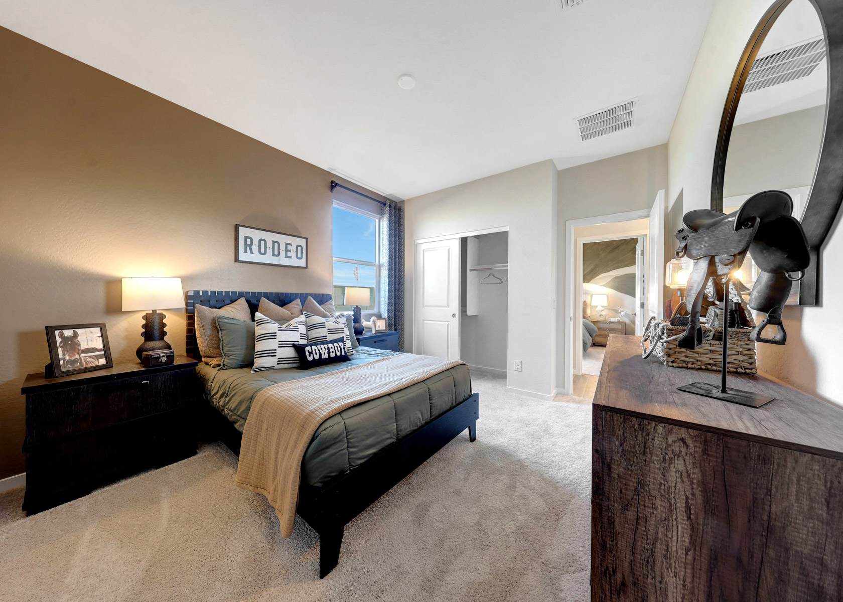 A bedroom with a large mirror.