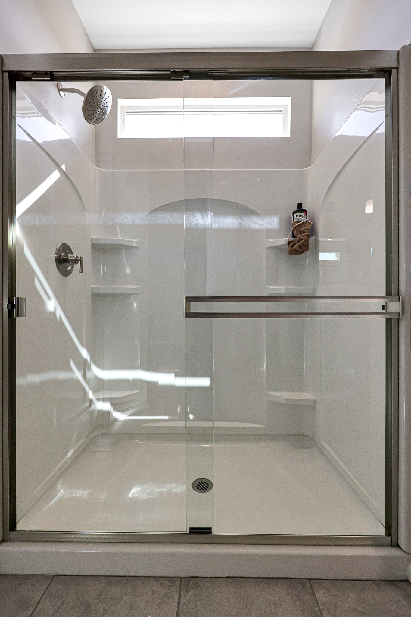 A shower with a glass door.
