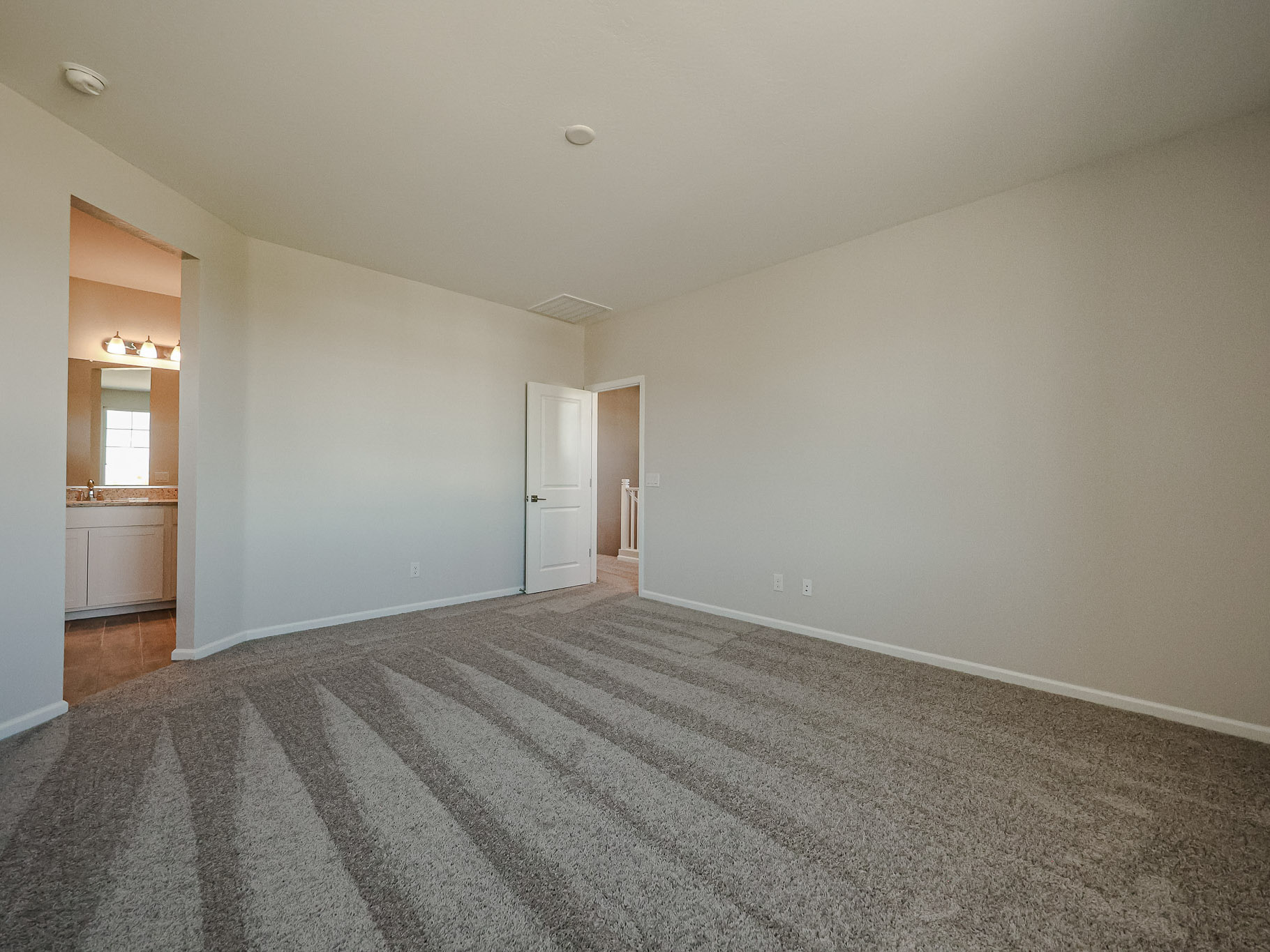 A room with a carpet and a rug.