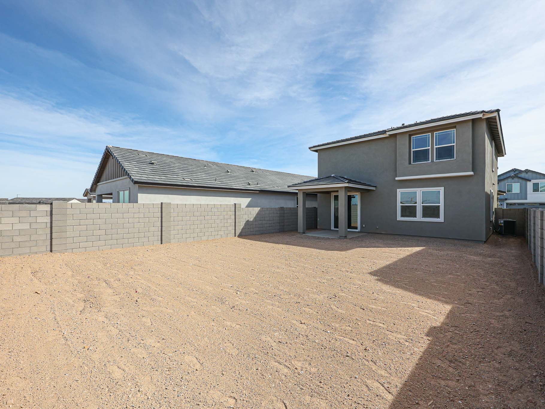 A house with a dirt yard.
