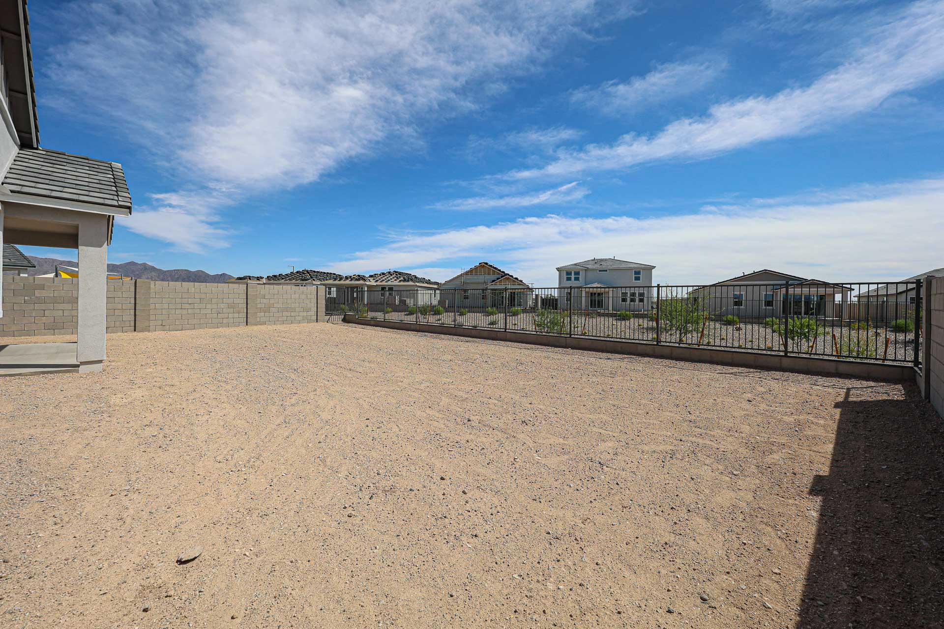 A sandy area with buildings in the background.