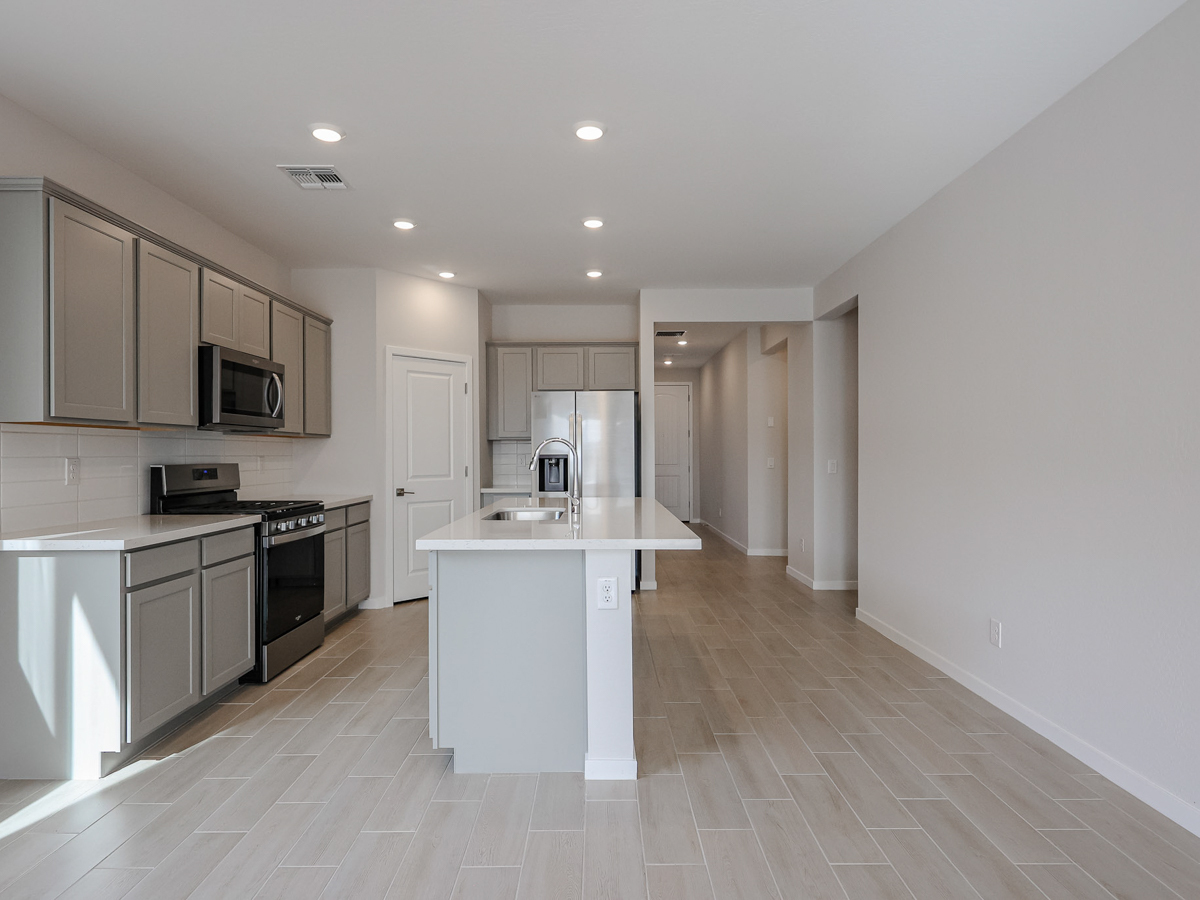 A kitchen with white cabinets.