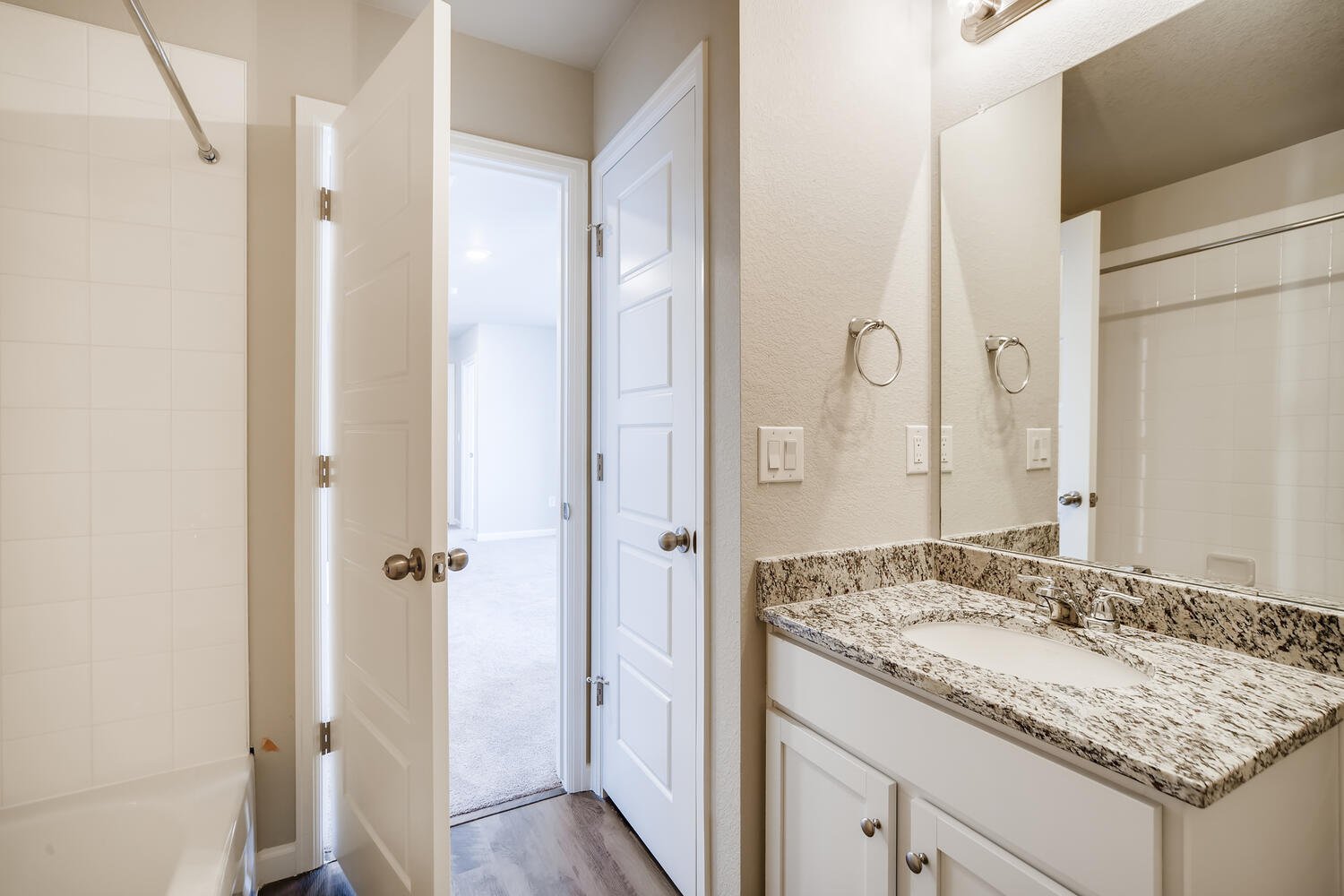 A bathroom with a marble countertop.