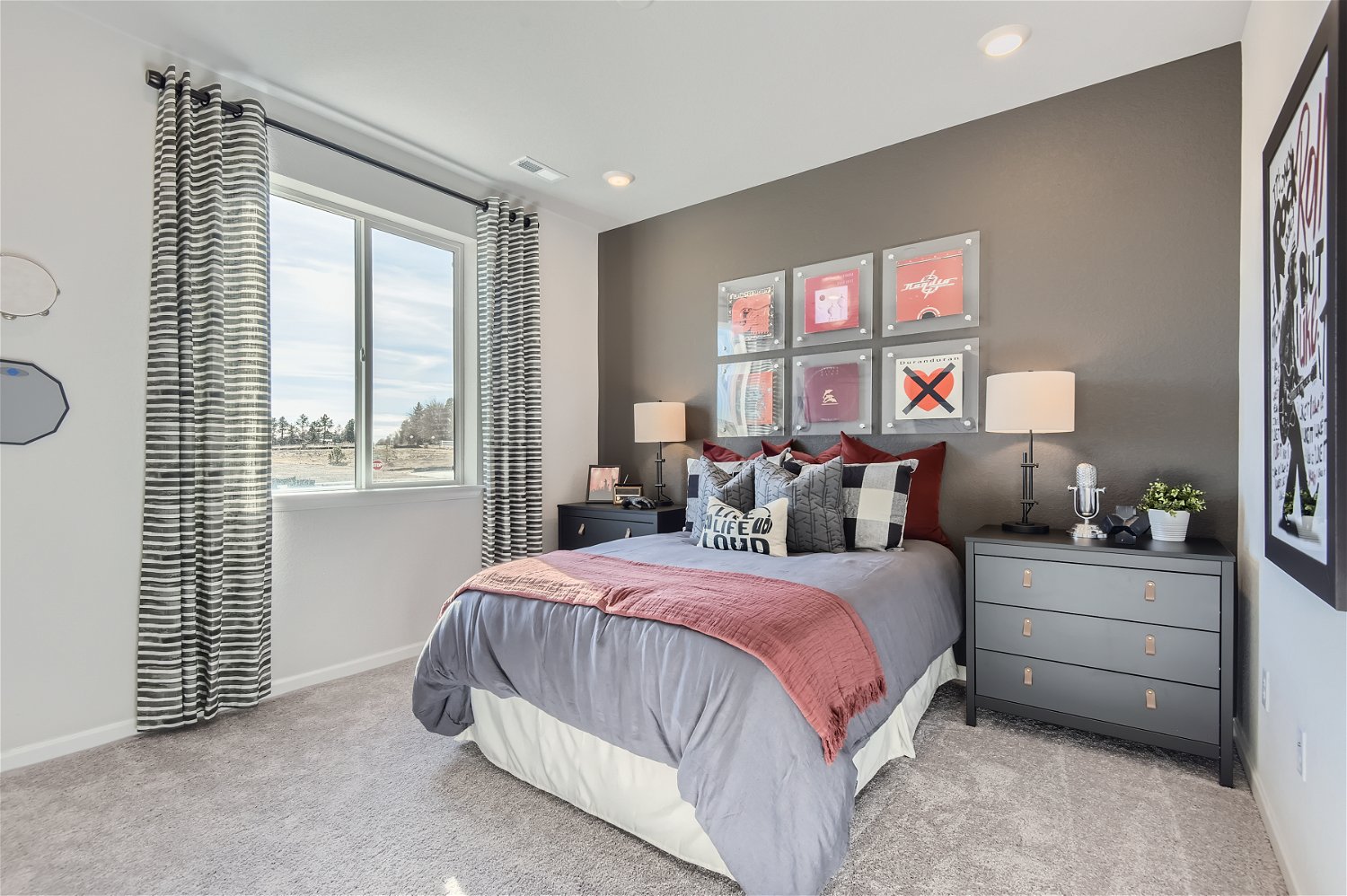 A bedroom with a bed and a window.