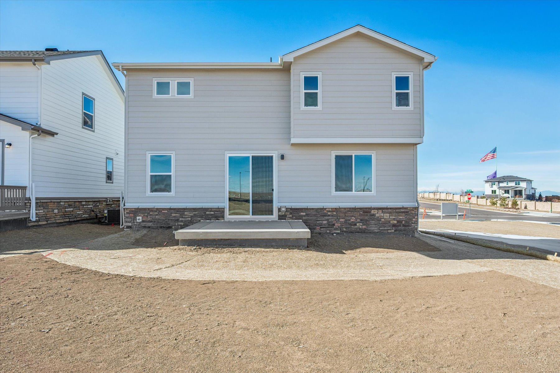 A white building with a flag on top.