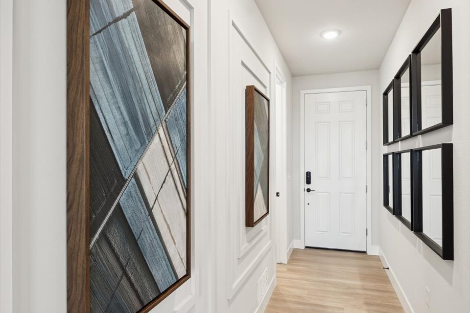 A hallway with black and white doors.