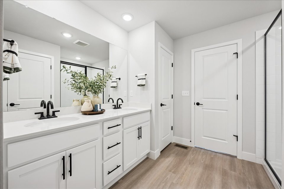 A bathroom with white cabinets.