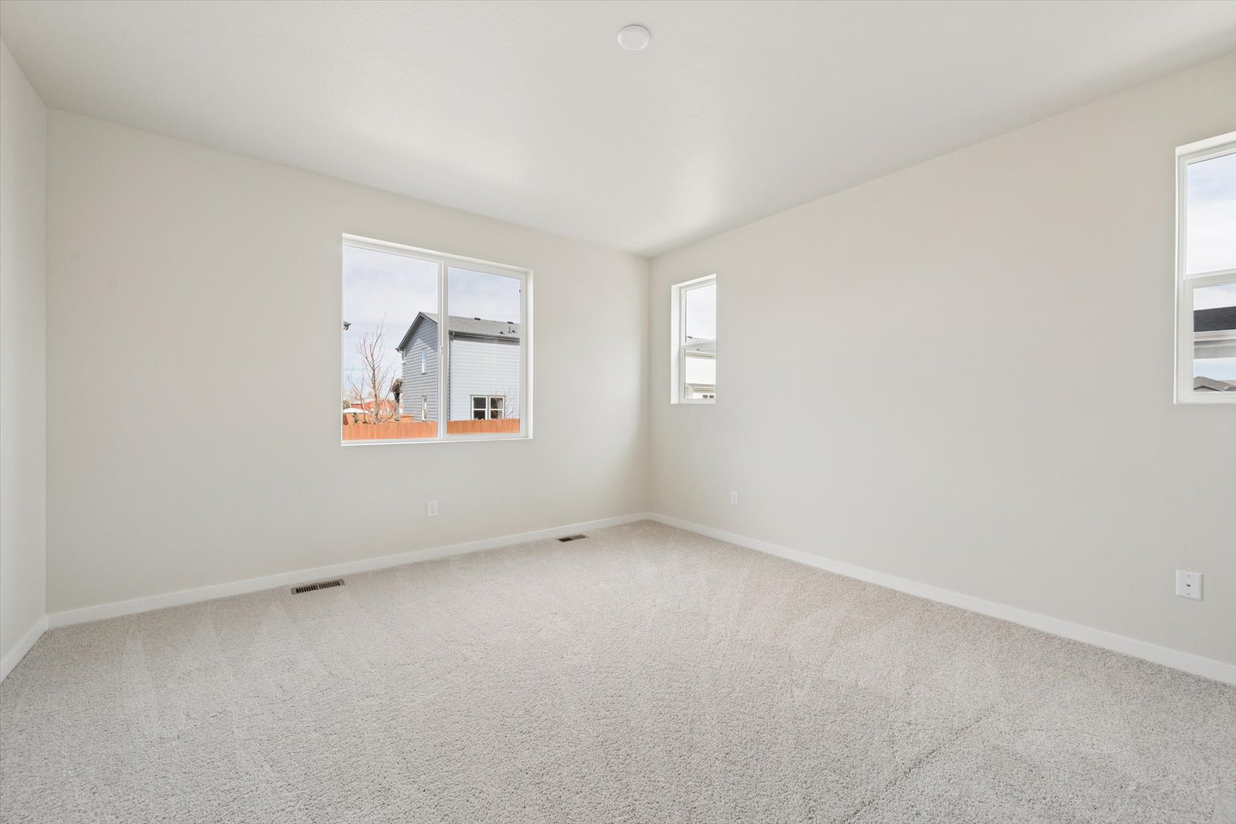 A room with a window and a carpet.