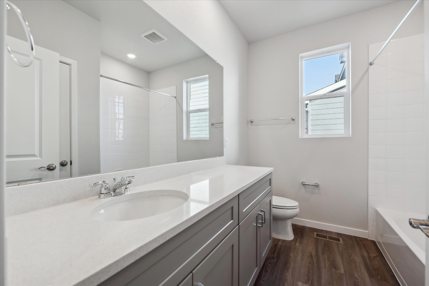 A bathroom with a large mirror.