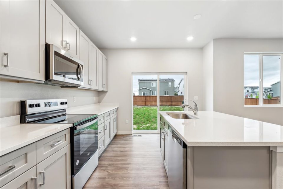 A kitchen with white cabinets.