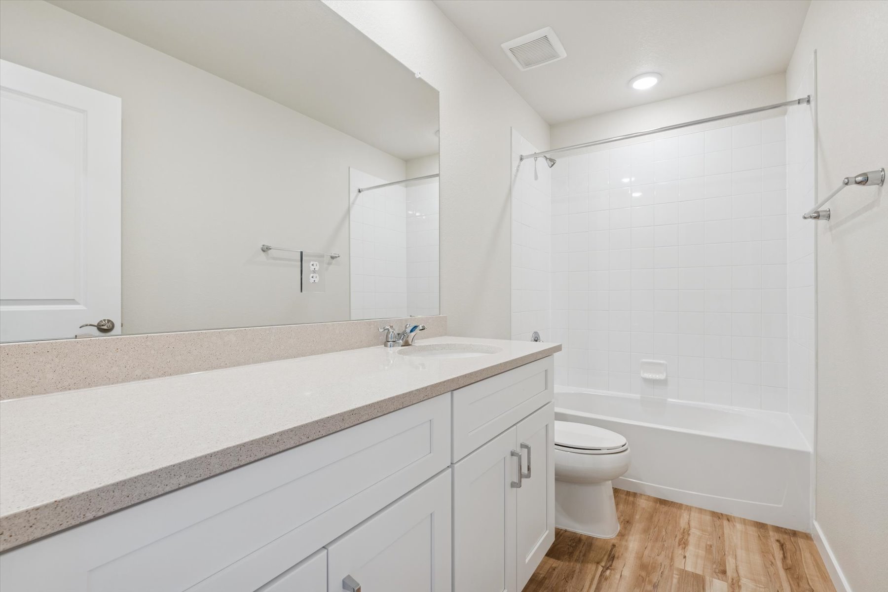 A bathroom with a tub toilet and sink.
