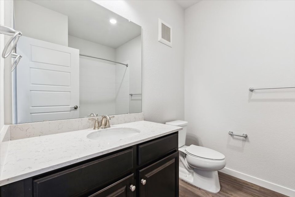 A bathroom with a sink toilet and shower.