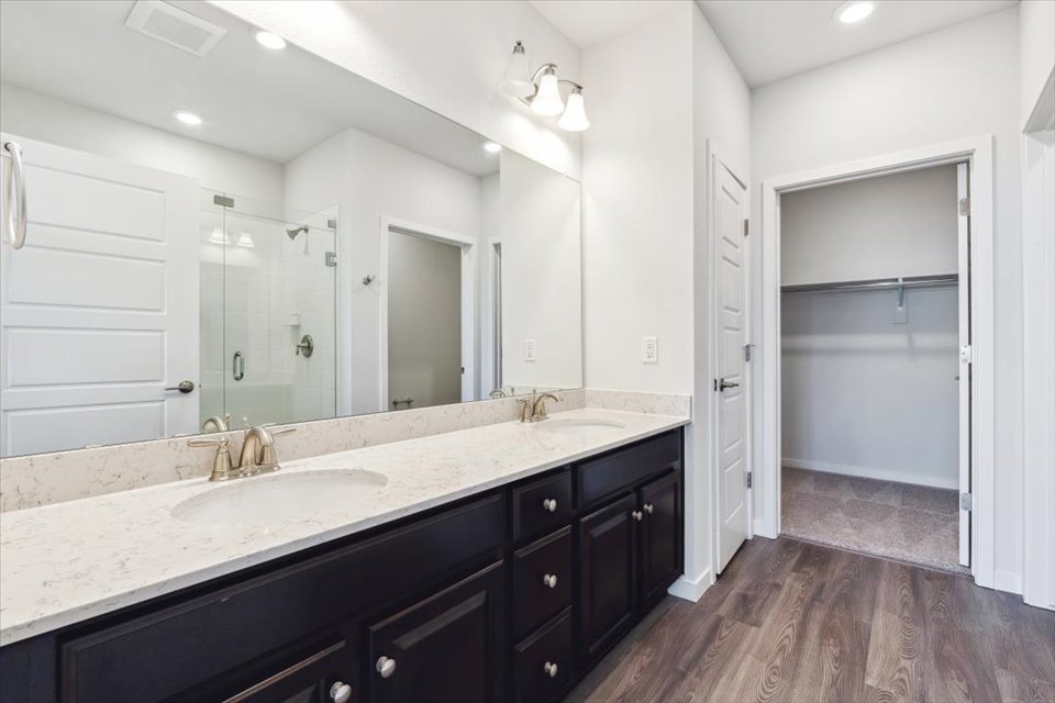 A bathroom with a large mirror.