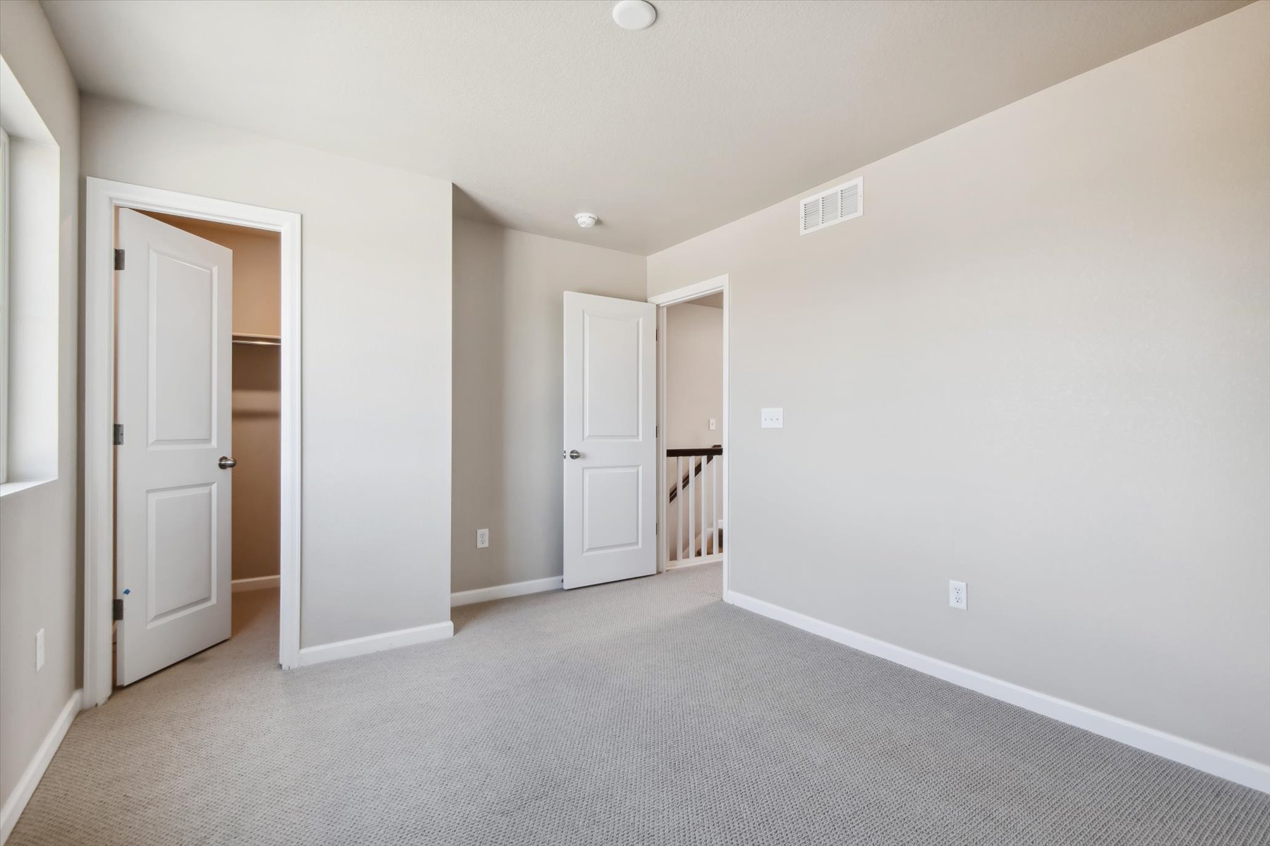 A hallway with white doors.
