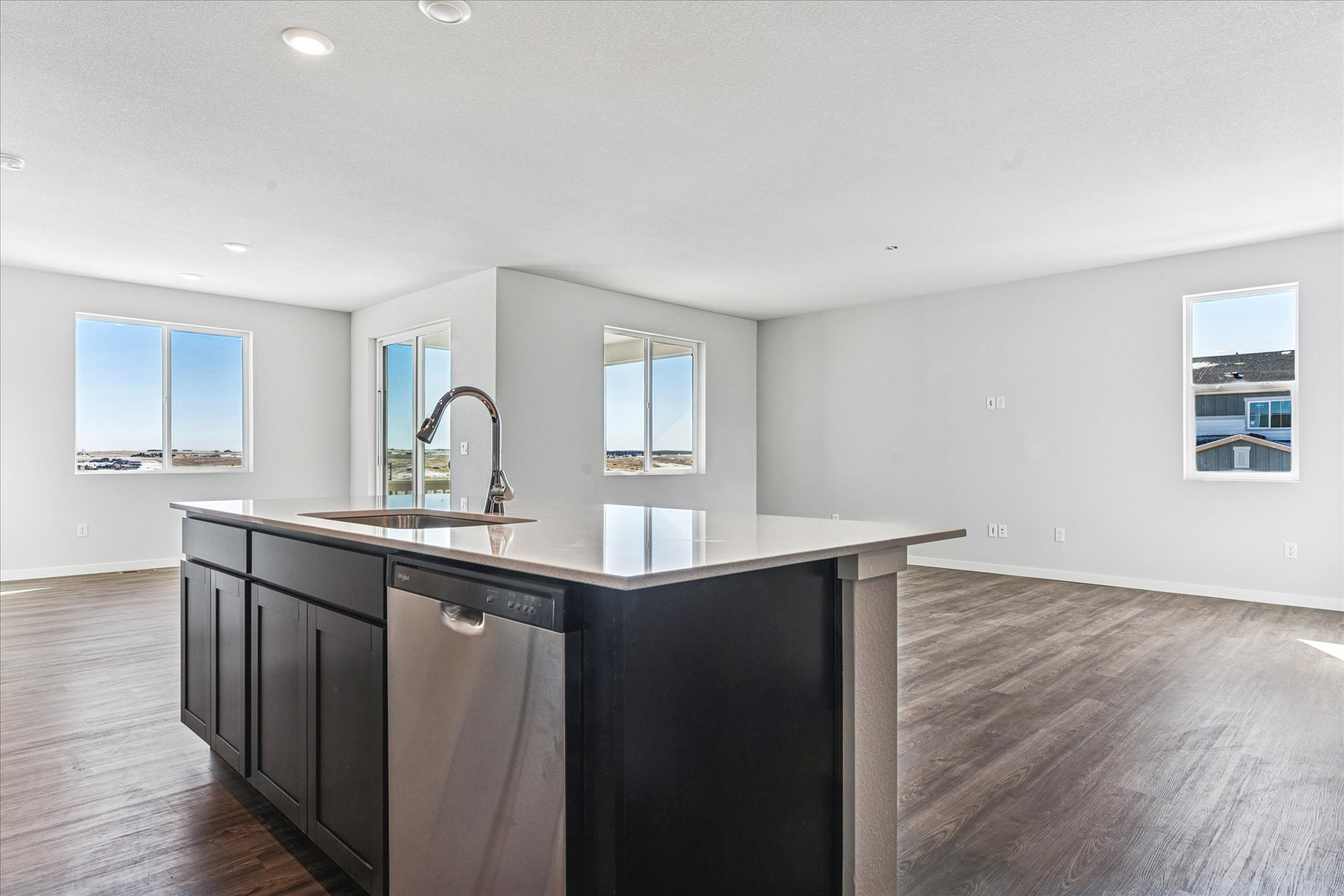 A kitchen with black cabinets.