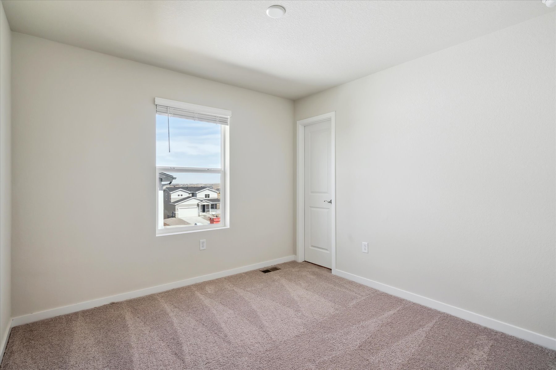 A room with a window and a door.