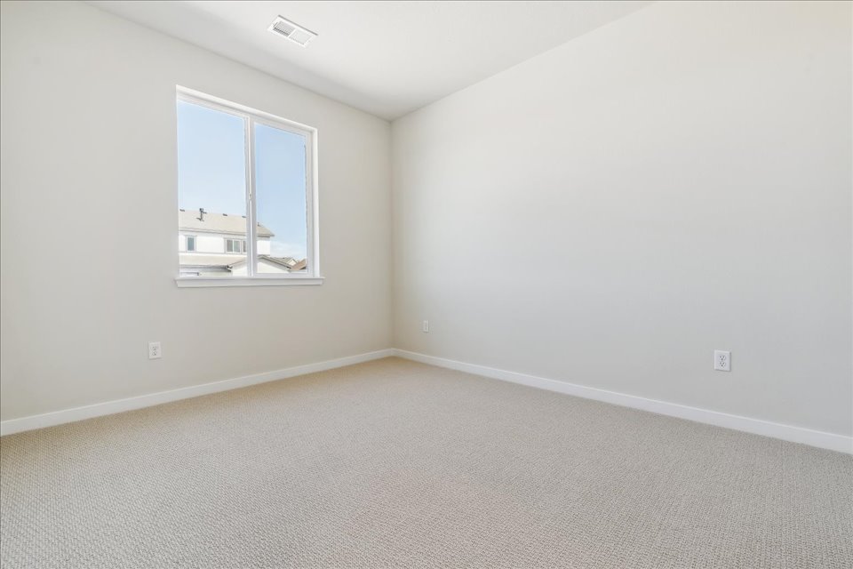 A room with a window and a carpet.