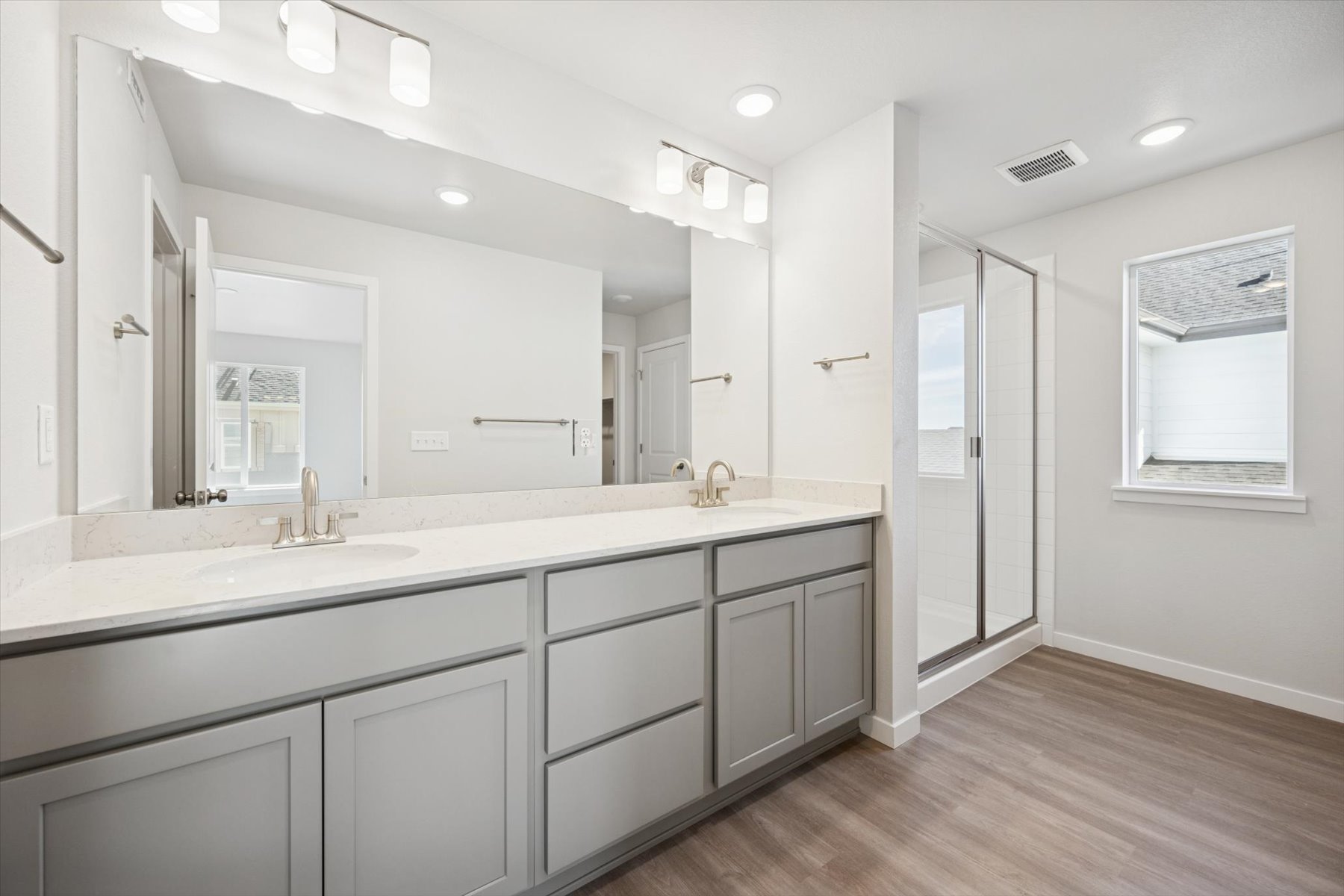 A bathroom with a large mirror.