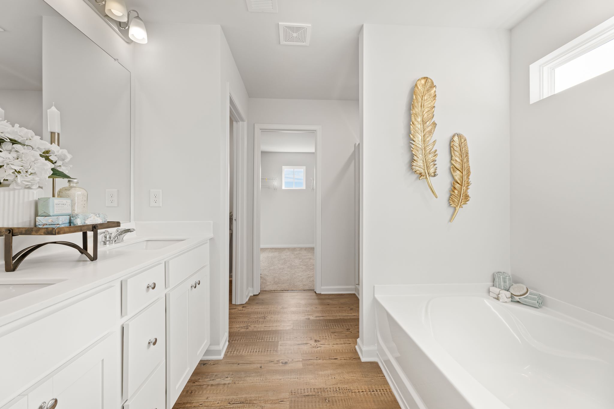 A bathroom with white cabinets.