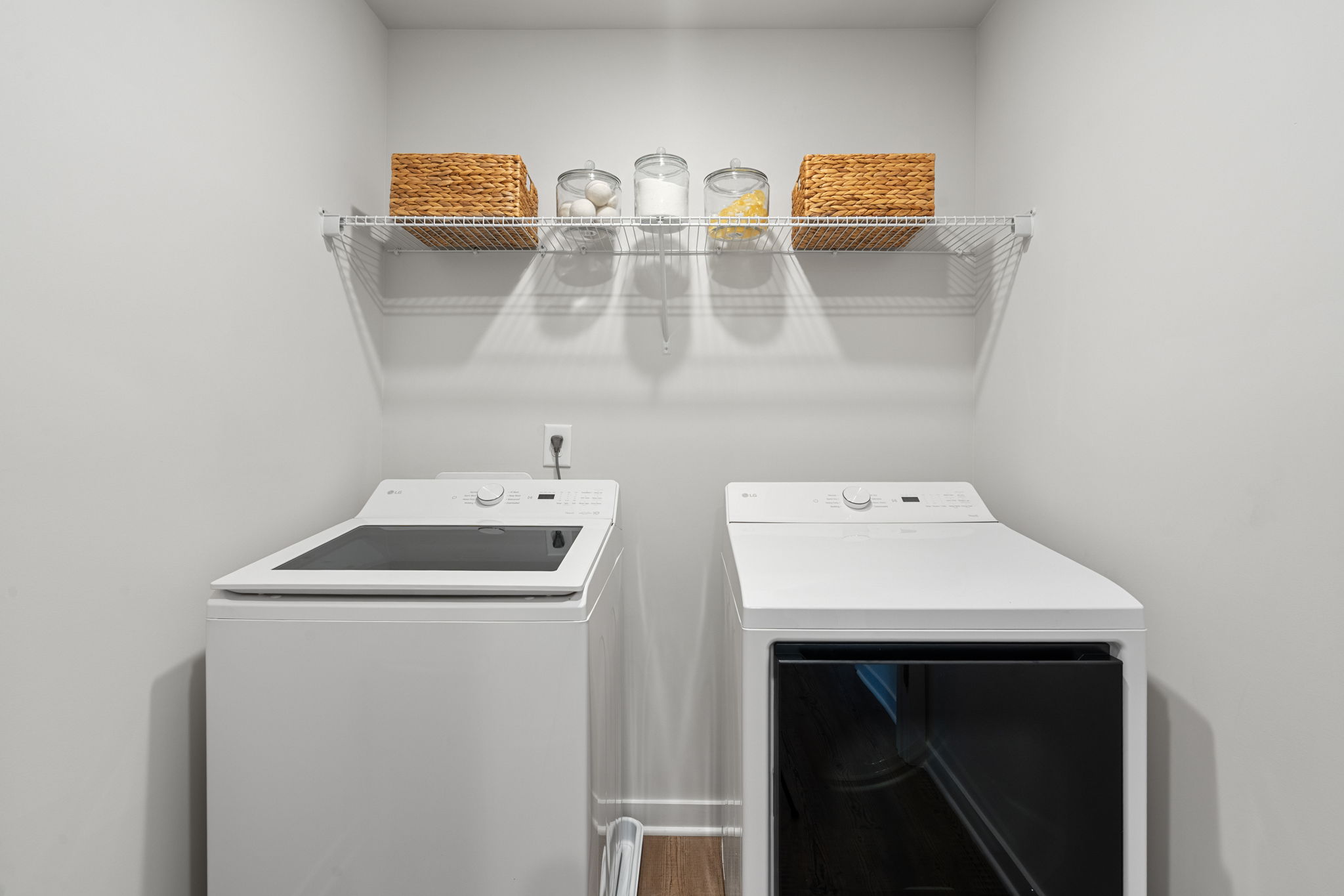 A kitchen with a shelf and a stove.