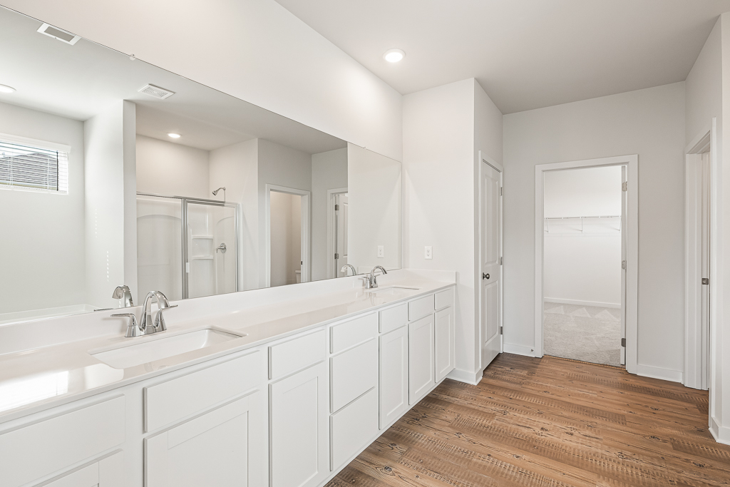 A bathroom with white cabinets.