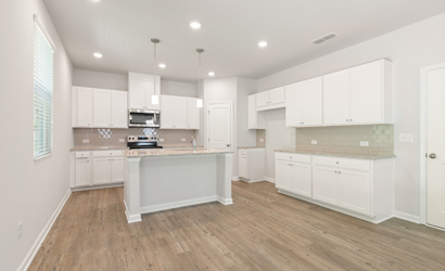 A kitchen with white cabinets.