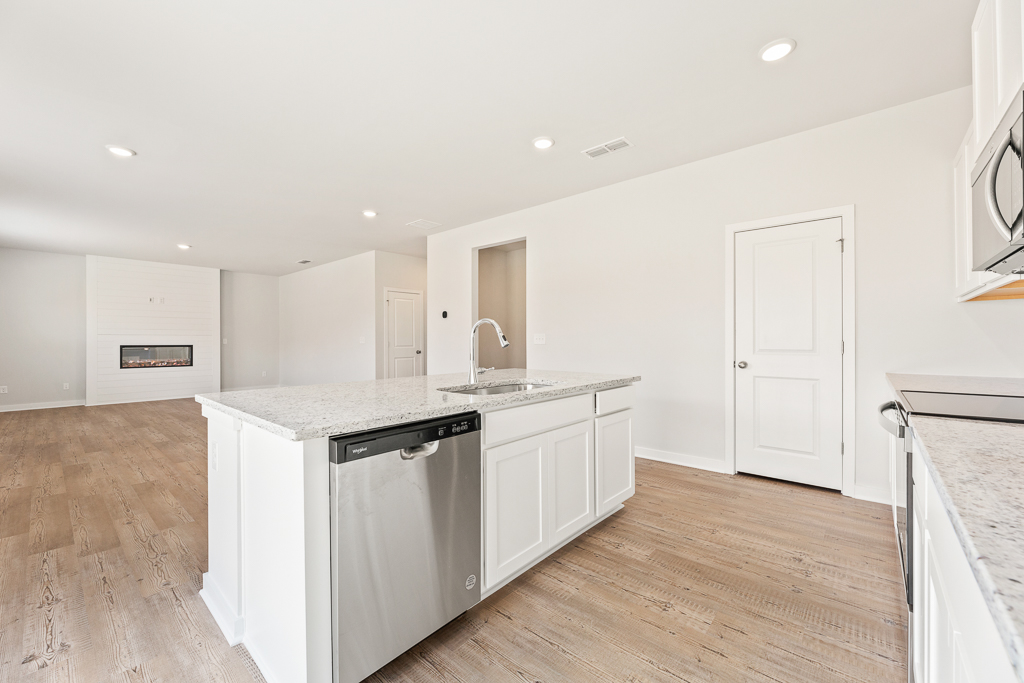 A kitchen with white cabinets.