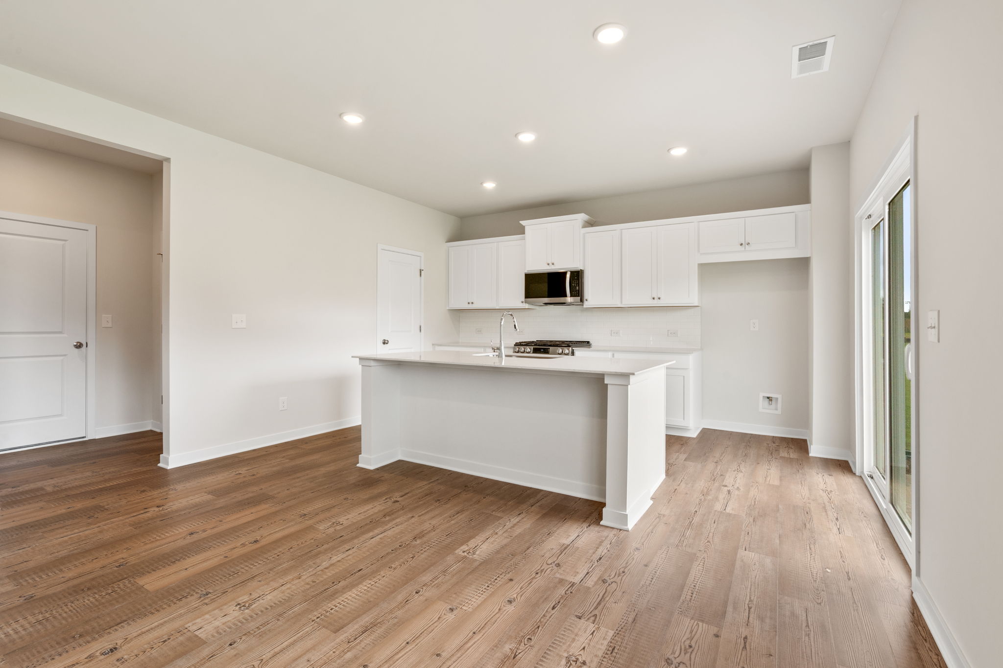 A kitchen with white cabinets.