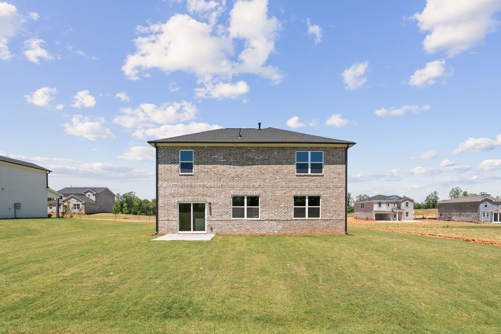 A building in a grassy field.