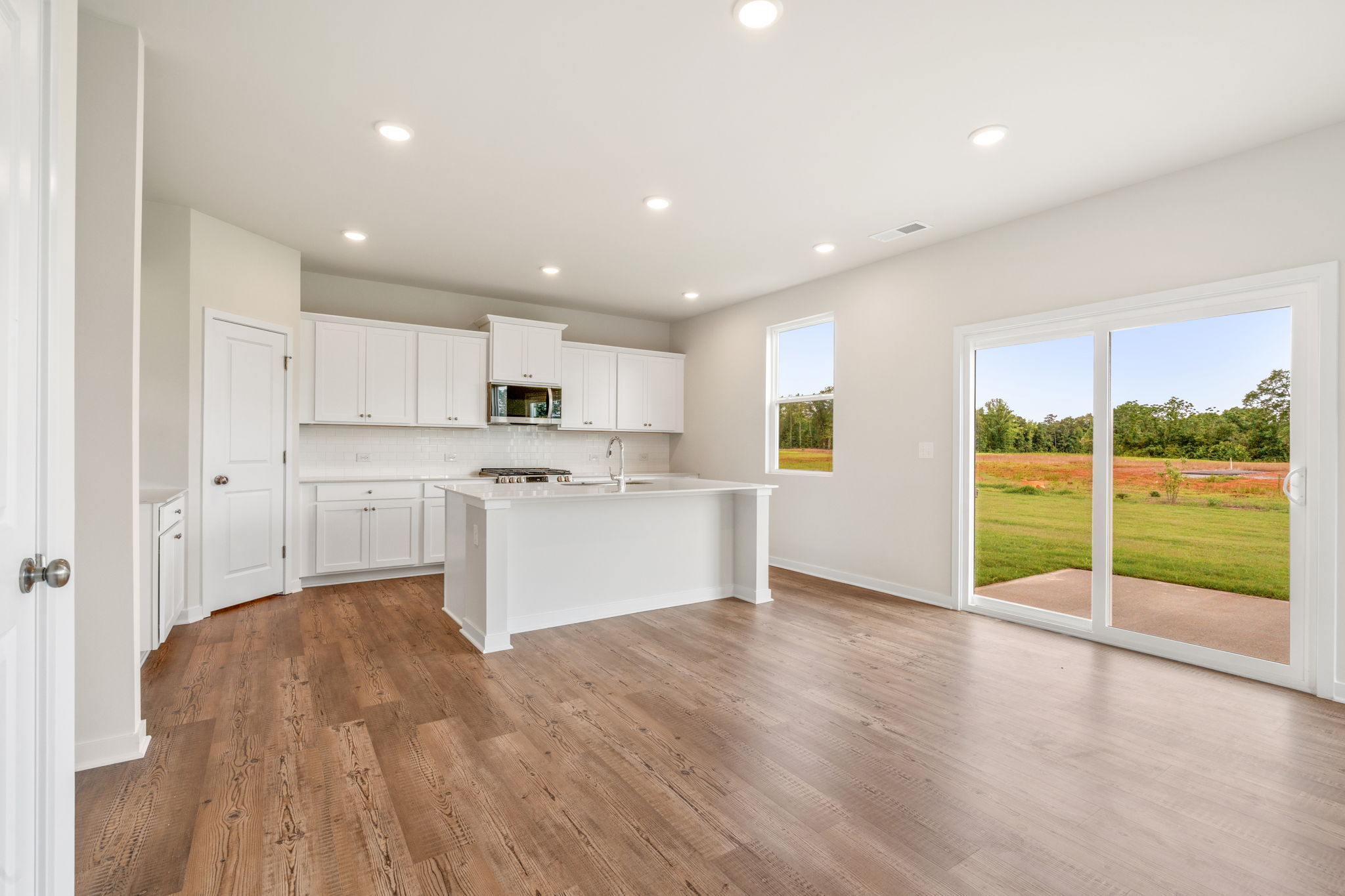 A kitchen with white cabinets.